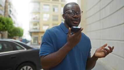 Young man talking on phone outside in urban city street