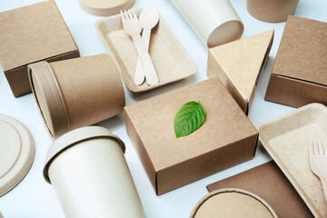 Green leaf on a pile of paper box and cardboard package biodegradable or recycling.The concept of...