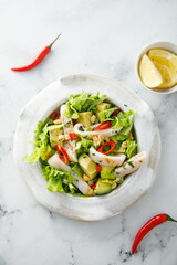 Squid salad with avocado and peanuts