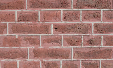 Close-up of brickwork with decorated gaps, red shade