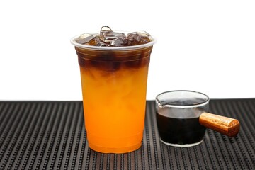 Put Americano ice coffee with orange juice on bar mat in white background with isolated concept.