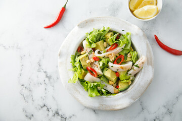 Squid salad with avocado and peanuts