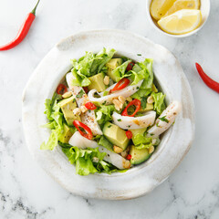 Squid salad with avocado and peanuts