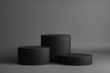 Three black cylindrical podiums on a grey background