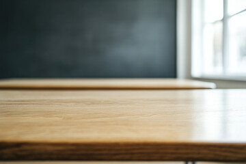A wooden table with a black background classroom