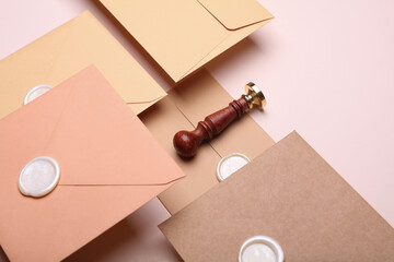 Floating Envelopes with wax seals and vintage stamp on beige background. Gift certificate, wedding...