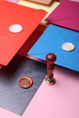 Floating colored Envelopes with wax seals, vintage stamp on pink background. Gift certificate,...