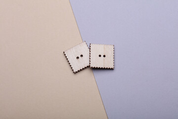 Wooden buttons on a pastel background close up
