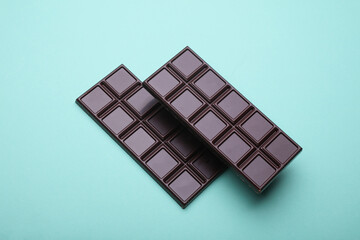 Dark chocolate bars on a blue background