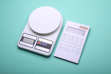 Kitchen scale with calculator on blue background