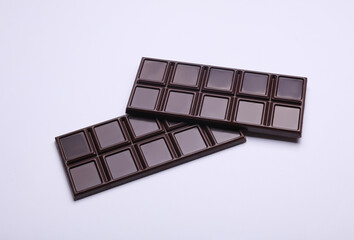 Dark chocolate bars on a white background