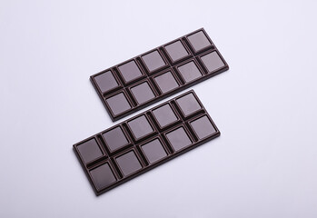 Dark chocolate bars on a white background