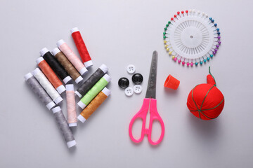Tailor sewing accessories on gray background. Top view