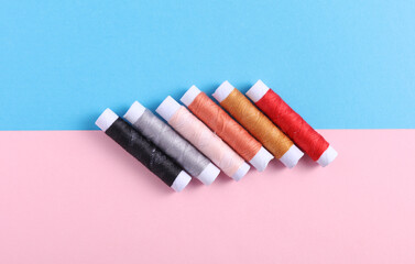 Skeins of thread on a blue pink background