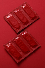 Condom packages on a red background