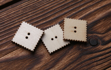 Wooden buttons on a wooden background