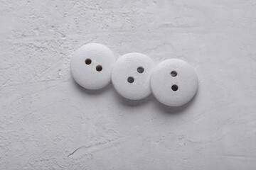 White Wooden buttons on a concrete background