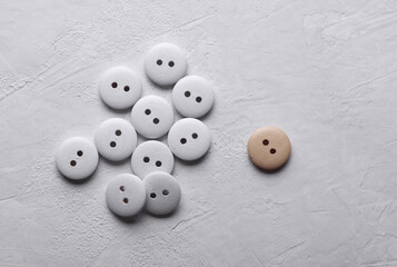 White Wooden buttons on a concrete background