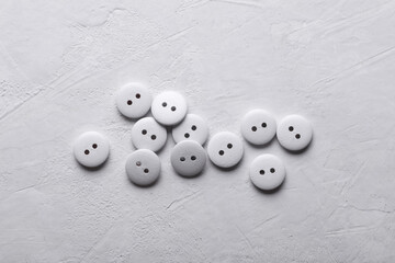 White Wooden buttons on a concrete background