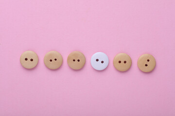  Wooden buttons on a pink background