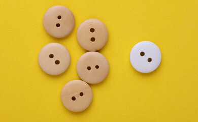 Wooden buttons on a yellow background