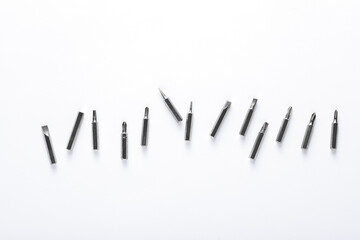 Set of metal screwdriver bits on white background