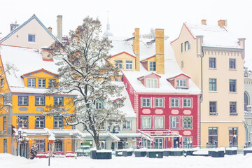 Old Town ( Vecriga) colorful buildings covered in snow in Riga, Latvia. Beautiful european cities, trendy tourist destinations, relaxed vacations, festive holidays.