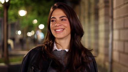 portrait of a beautiful, young woman enjoying an evening walk in the city