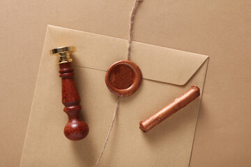 Envelope with wax seals and vintage stamp, thread on beige background. DIY, Gift certificate,...