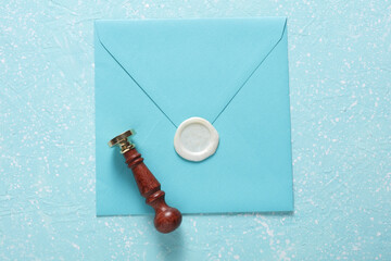 Envelope with wax seal and vintage stamp on blue concrete background. Gift certificate, wedding...