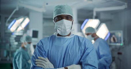 Portrait of a Black African American Male Doctor or Surgeon Wearing a Protective Face Mask and Disposable Surgical Cap. Medical Person Calmly Looking at Camera in Operating Room - Powered by Adobe