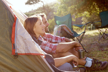 Morning, camping and couple with coffee, relax and travel adventure holiday in countryside together. Forest, man and woman thinking at tent with drink, peace and outdoor bonding vacation in nature.