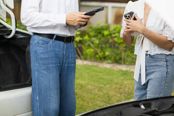 salesman is checking condition of car before delivering it to customer to ensure the quality and service after agreeing to sales contract. concept of checking the condition of the car for confidence