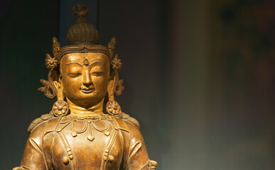 Close-up view on Gilt Bronze Statue Of Vairocana -also Mahavairocana- Is Cosmic Buddha From Mahayana And Vajrayana Buddhism. In Conception Of Five Jinas Of Mahayana And Vajrayana Buddhism, Vairocana