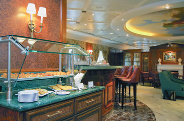 Cozy living room atmosphere inside cafe café coffee shop bar lounge bistro onboard luxury cruiseship cruise ship liner in contemporary country club interior design