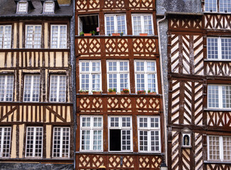 A close-up view of traditional half-timbered houses showcasing intricate wooden frameworks and...