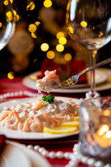 Festive fish table with Skagen salad - traditional Swedish starter dish with shrimps. Celebration delicacies on Christmas table in Finland and Scandinavia