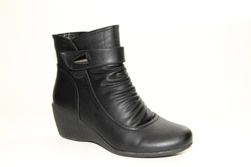 Women's Winter Boots and Shoes. On a white background. Side view. Unbranded model.