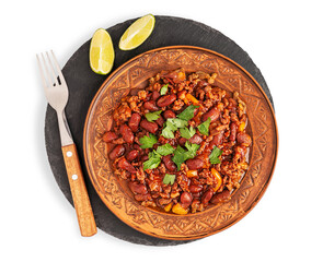 Top view of homemade spicy traditional Mexican chili con carne stew made of ground beef meat, tomatoes, and pinto or kidney beans served on brown clay plate with lime slices and fork isolated on white