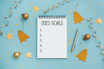 2025 goals list with notebook and pen on festive background. Resolutions, plan, goals, action,...