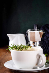 Cup of scented aromatic rosemary coffee latte, with whipped milk or cream