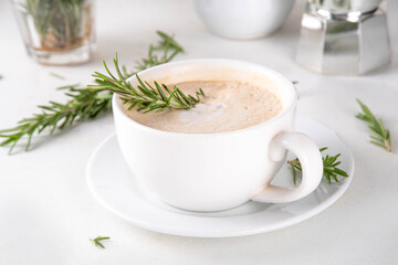 Cup of scented aromatic rosemary coffee latte, with whipped milk or cream