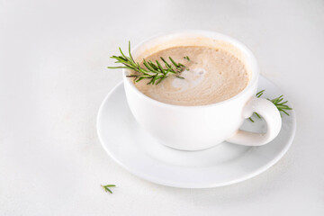 Cup of scented aromatic rosemary coffee latte, with whipped milk or cream