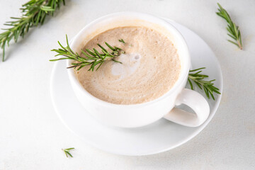 Cup of scented aromatic rosemary coffee latte, with whipped milk or cream