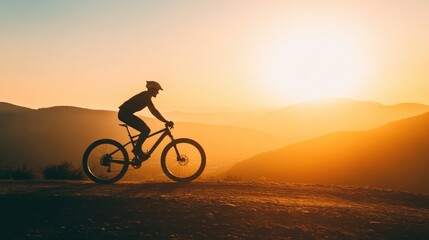 Fototapeta premium Mountain Biker Silhouette at Sunrise in Scenic Landscape