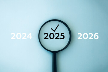 2025 inside of Magnifying glass in between previous and next year on blue background. Focus current year, achievement, target concept