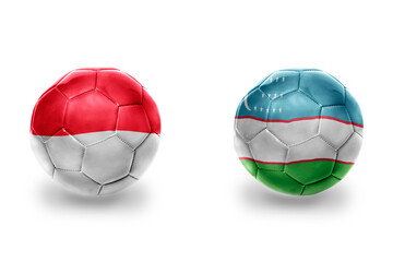 Fototapeta premium football balls with national flags of uzbekistan and indonesia,soccer teams. on the white background.