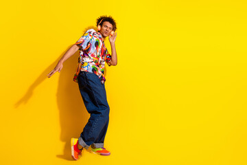Fototapeta premium Full body portrait of nice funky young man headphones empty space wear shirt isolated on vibrant yellow color background