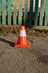 Orange road cone with white stripe