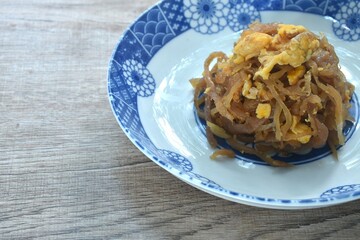 fried slice sweet Chinese pickled radish with egg in soy sauce on dish